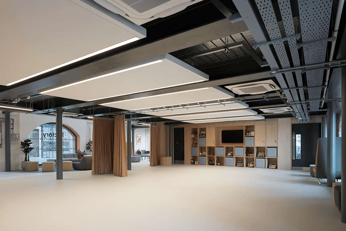 The Full Encore event space. A spacious, flexible room with a presentation screen and an optional dividing curtain for privacy.